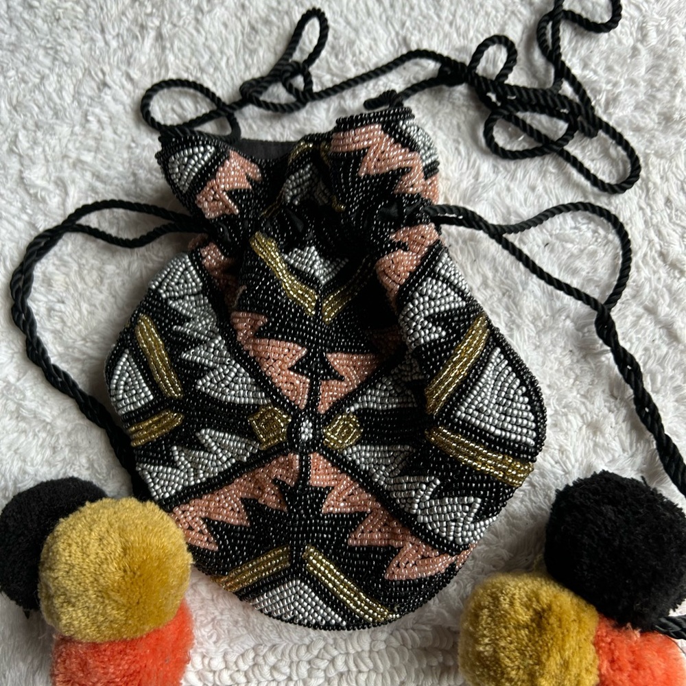 From st Xavier beaded bag long cord cinch style Pom poms